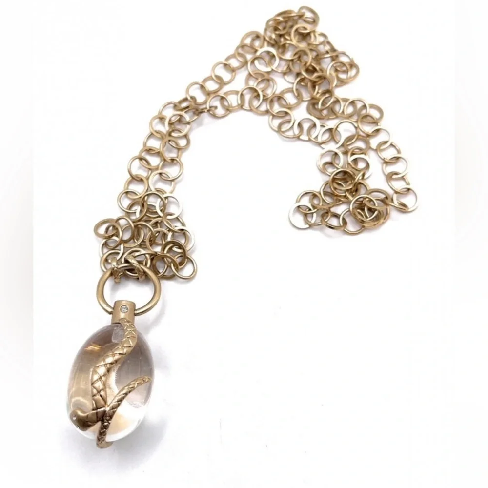 Vintage golden Snake wrapped around an elongated oval crystal